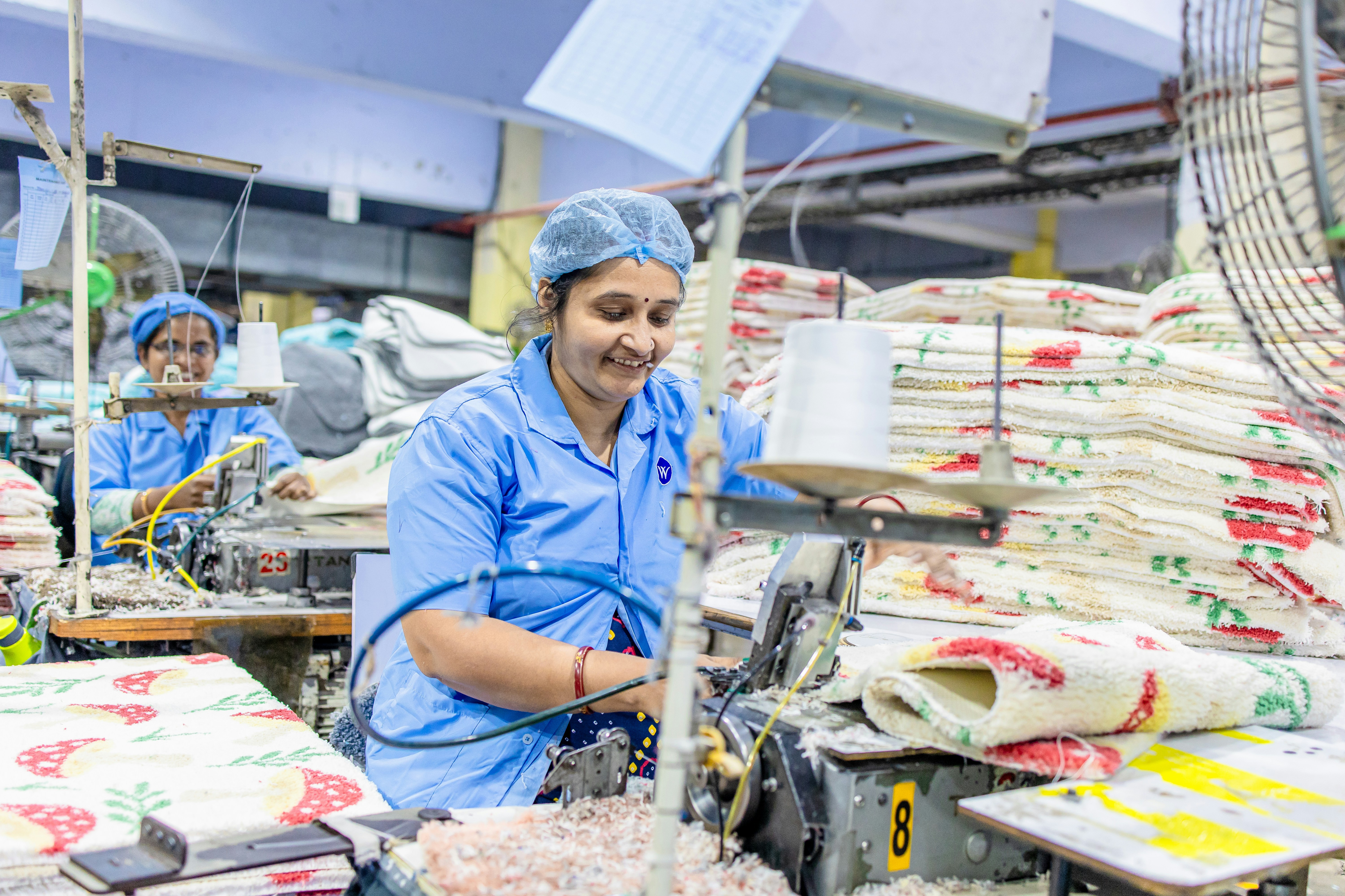 Factory workers are manufacturing goods in a factory.