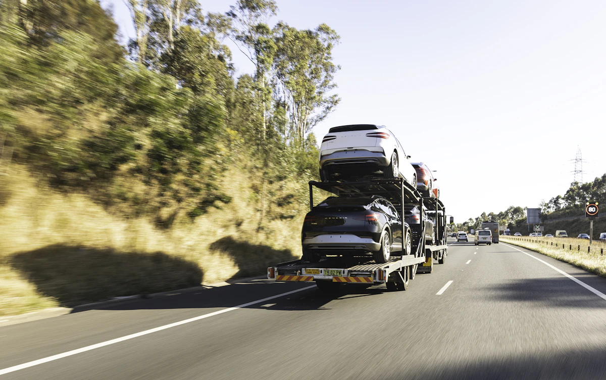 Open auto carrier providing Texas car shipping on a highway