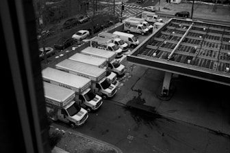 Delivery trucks lined up at a gas station.