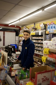 A store clerk smiles while working at the counter.