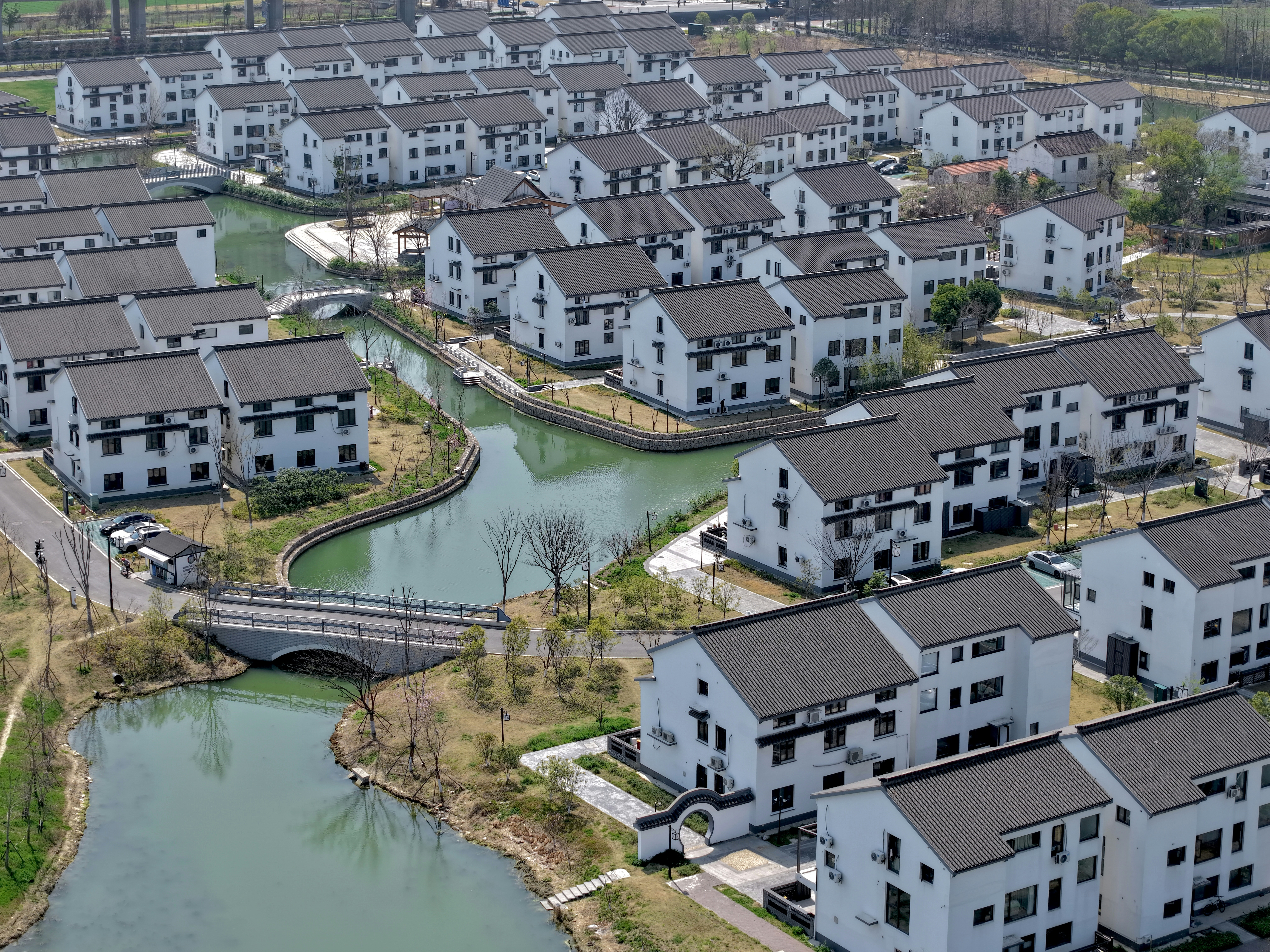 A residential neighborhood with canals and white houses