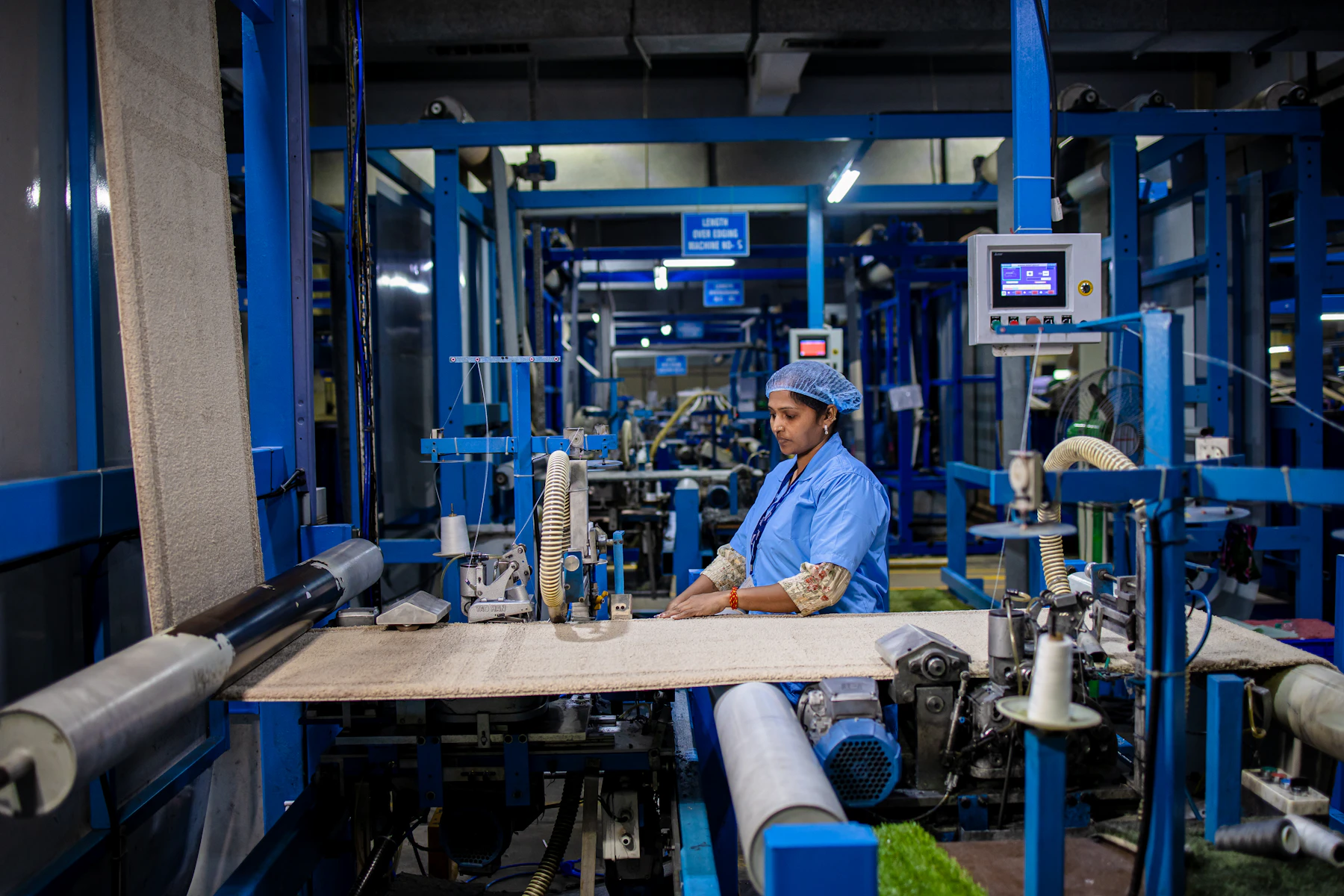 Worker operating machinery on an Indian factory floor