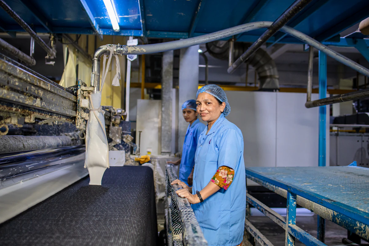 Cloth running beside production machinery while it is inspected