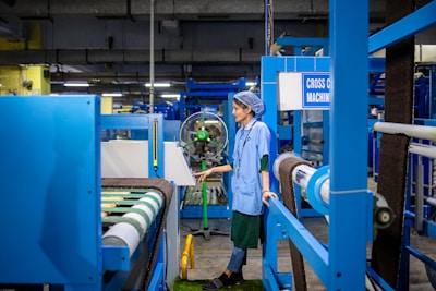 A worker operates machinery in a factory.