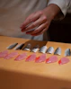 Sushi chef prepares fresh fish slices.