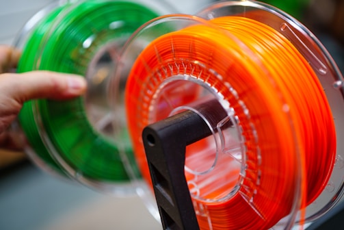Spools of colorful filament for 3D printing.