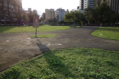 A park with buildings in the background.