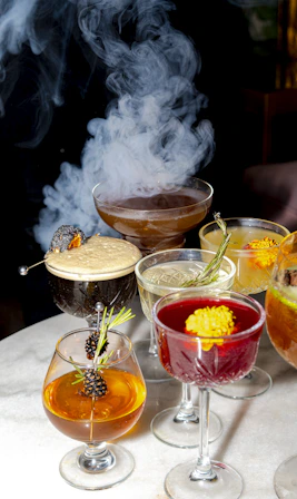 Elegant cocktails with smoky presentation.