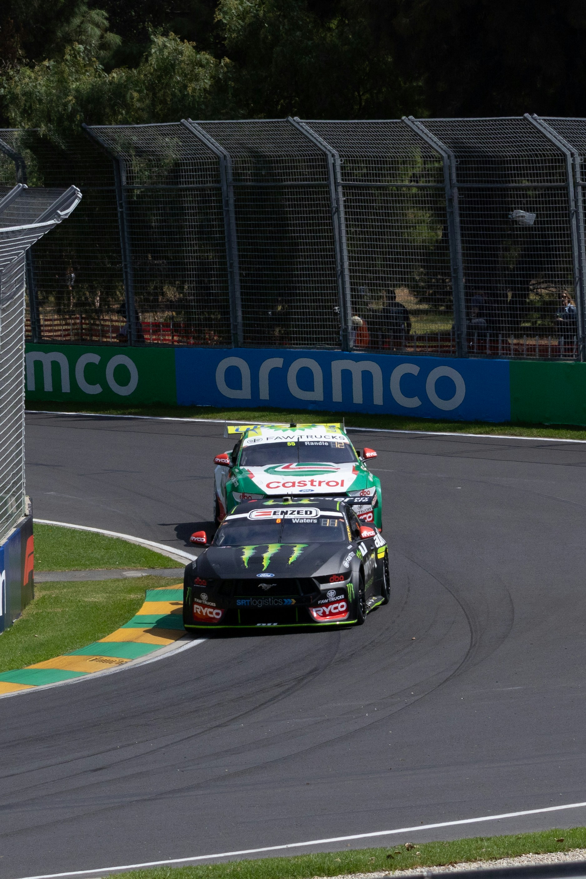 Race cars are competing on a curved track.