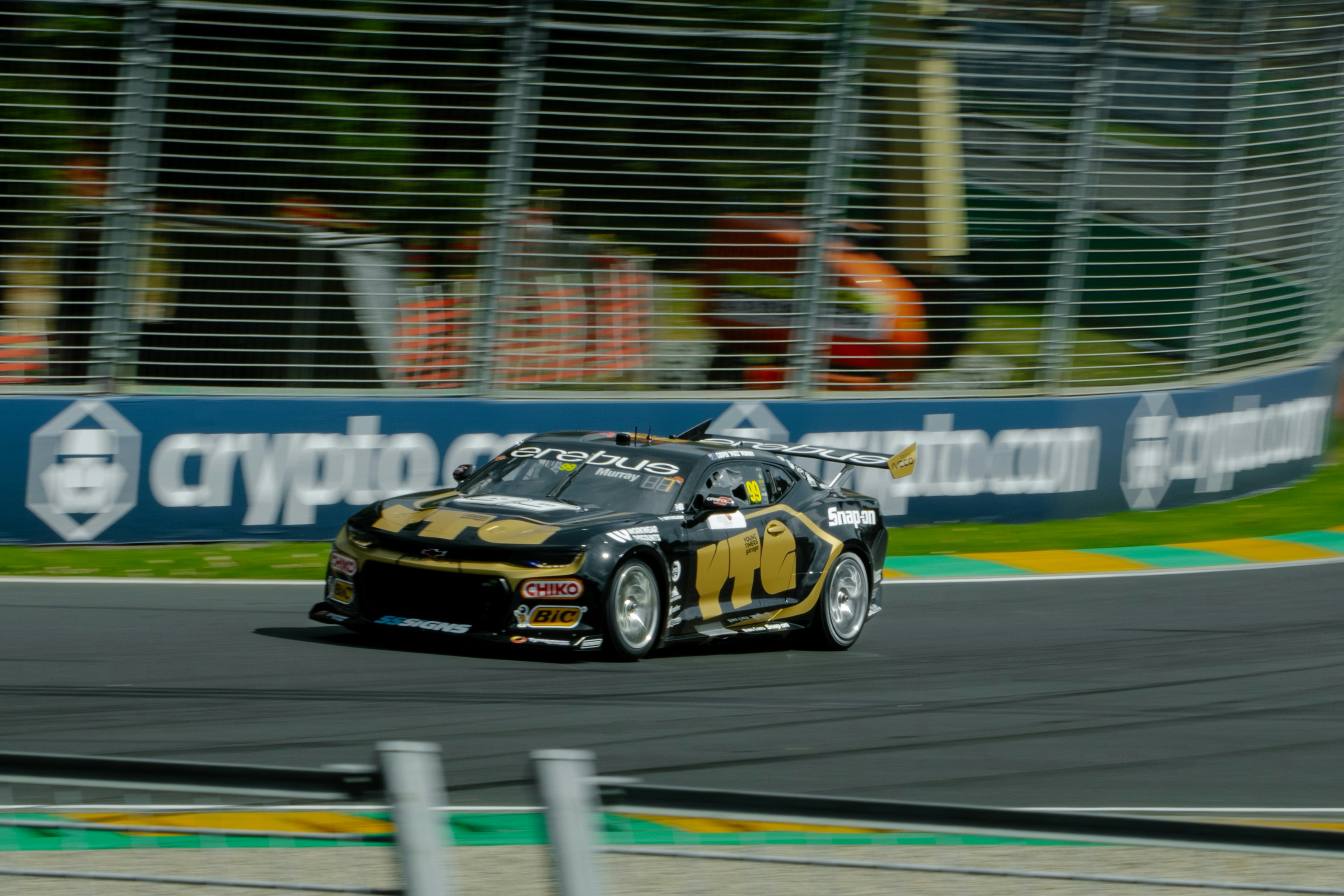 A race car speeds along a racetrack.