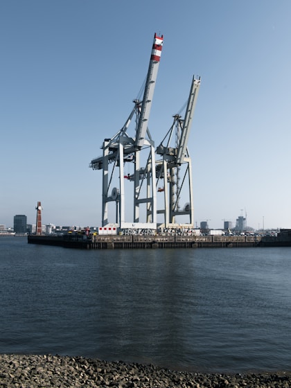 Large cranes stand tall over the water.