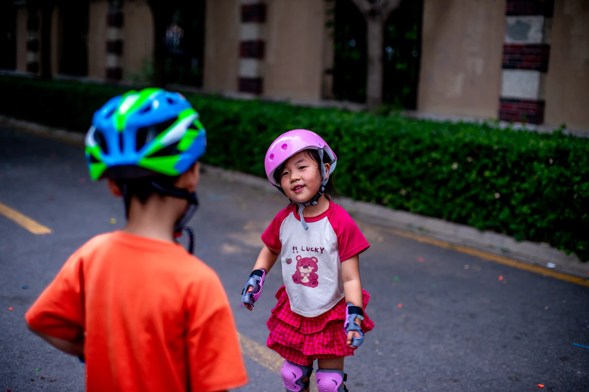 Two children are ready to roller skate.