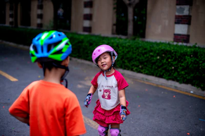 Two children are ready to roller skate.