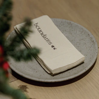 Napkins with "boundaries" are stacked on a plate.
