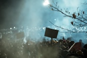 A crowd gathers, possibly protesting.