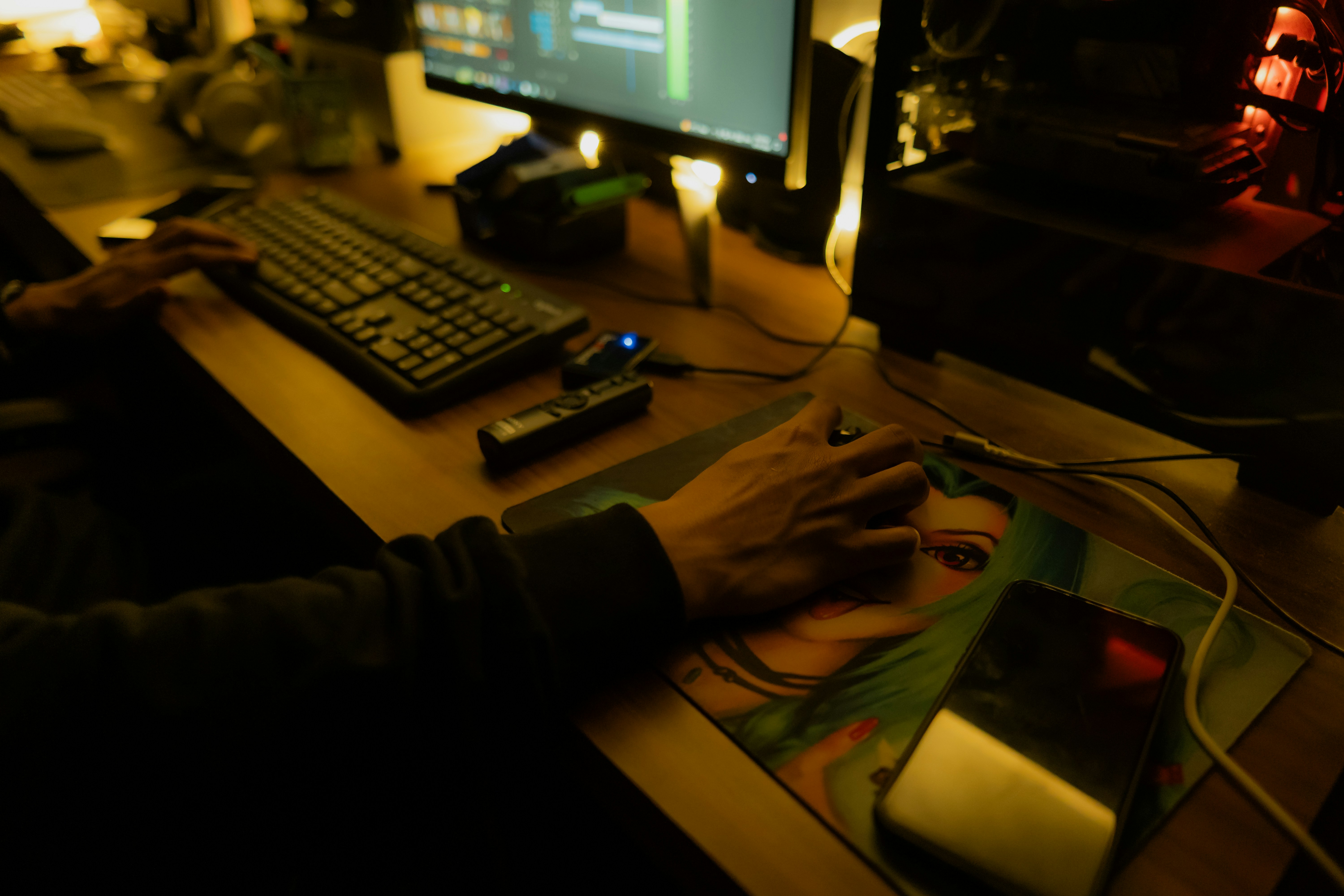 Person using a computer at a desk.