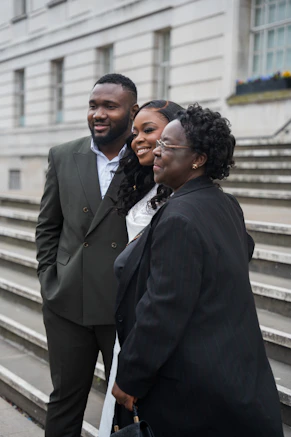 Family poses together outside a building.