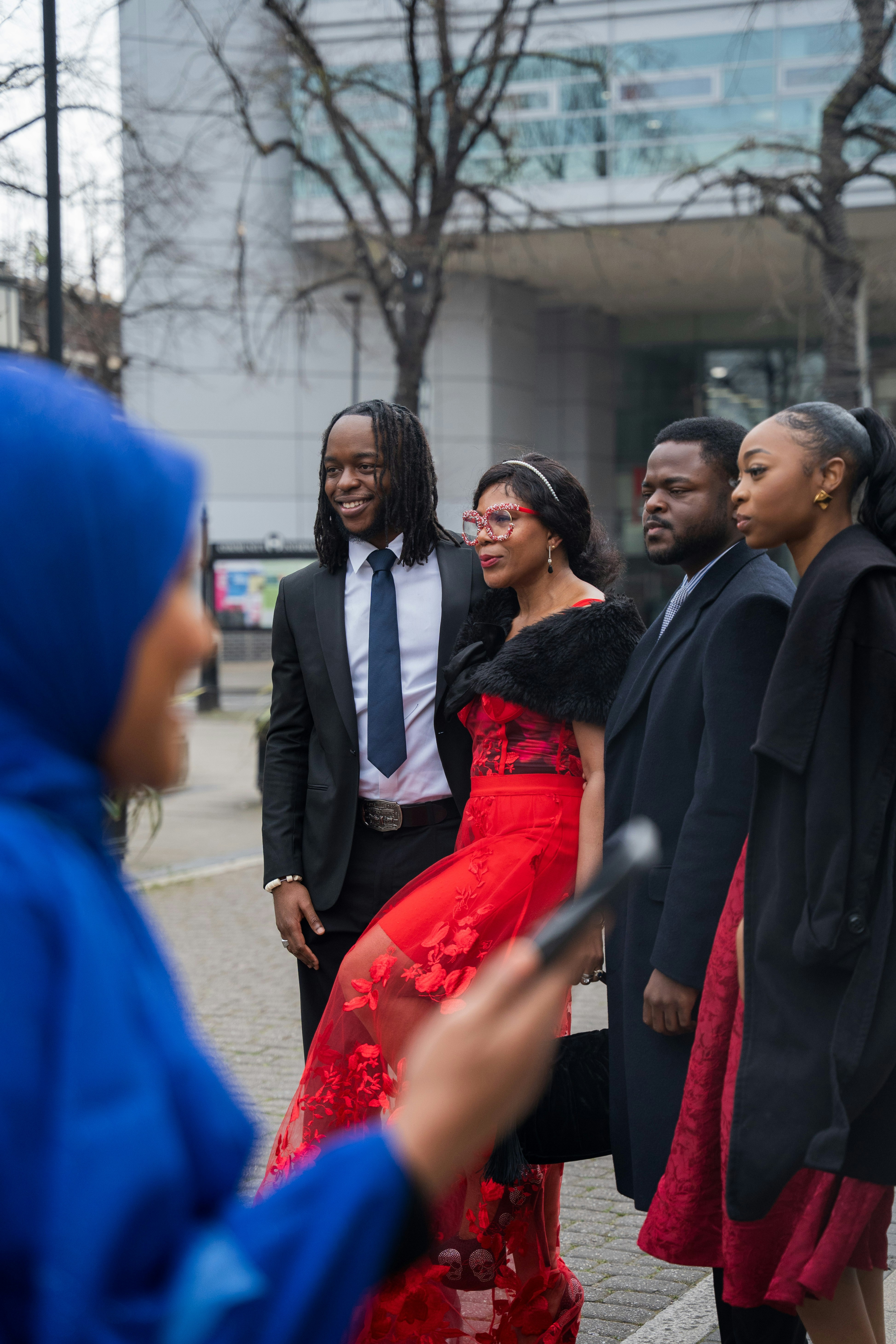 People pose for a picture outdoors, smiling.