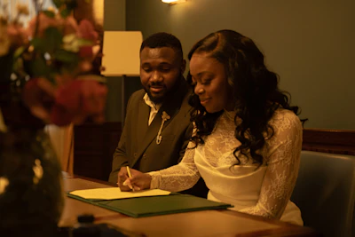 A couple signs their wedding papers.