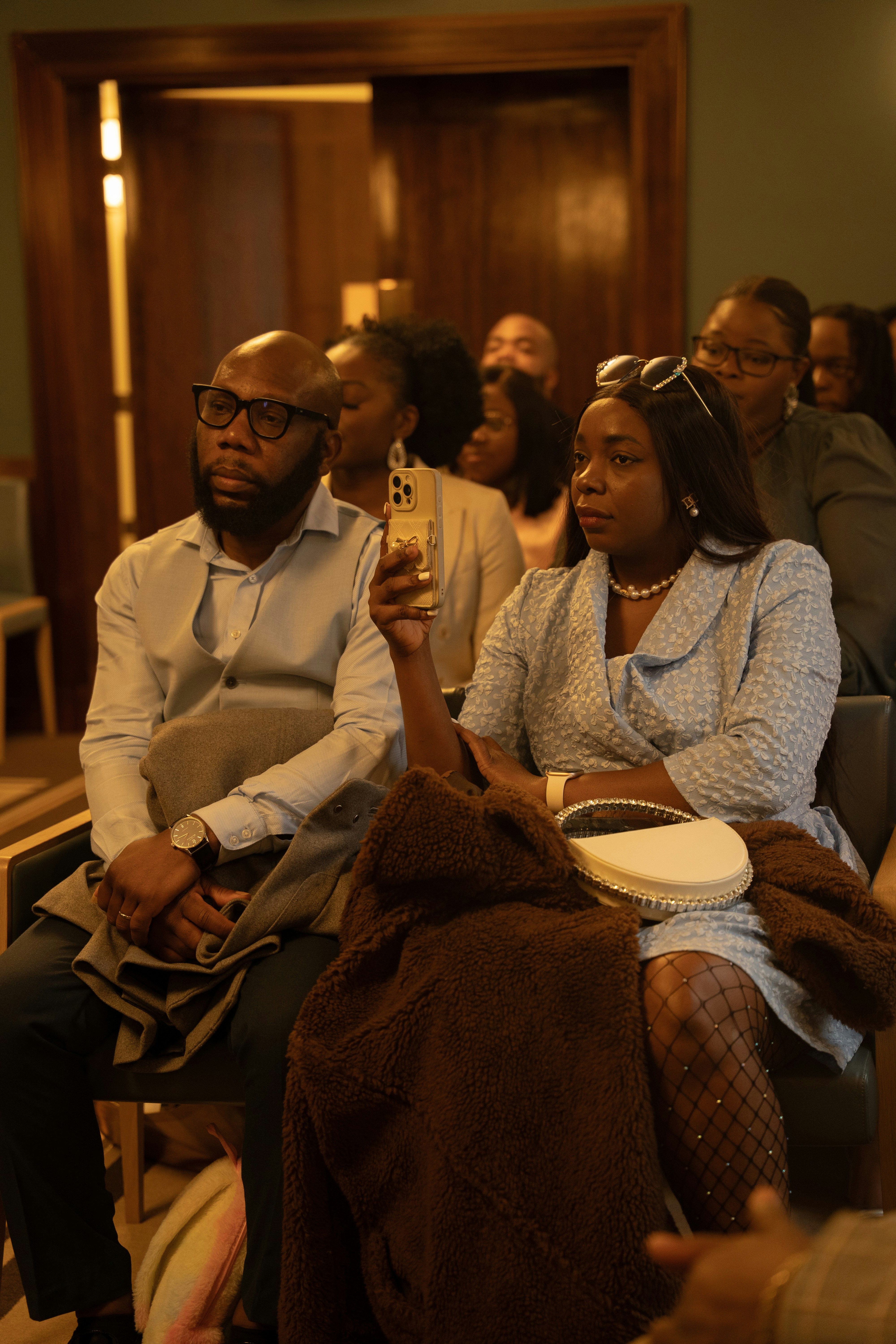 People sit attentively in a meeting.