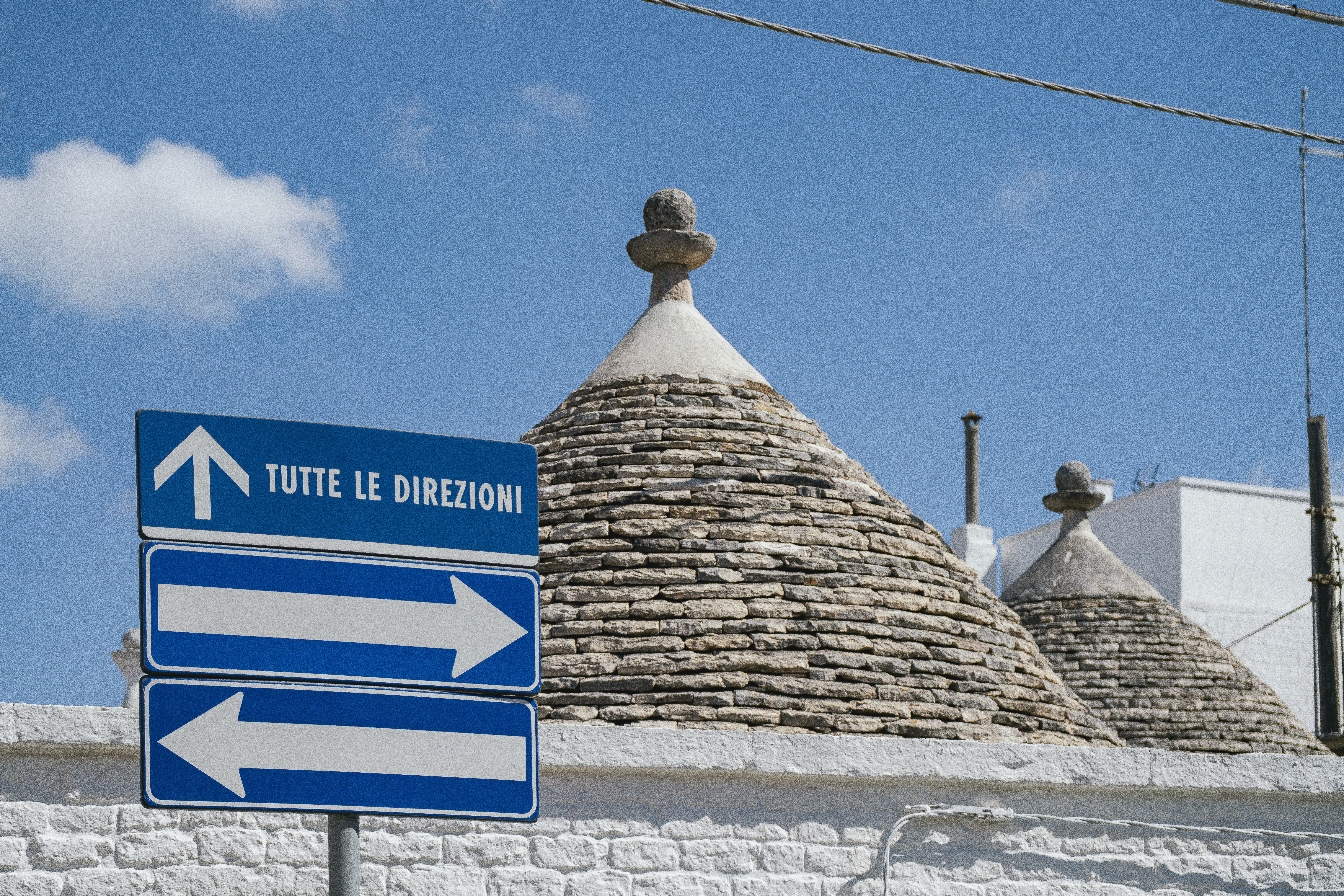 Road signs are in front of traditional italian buildings. photo – Free ...