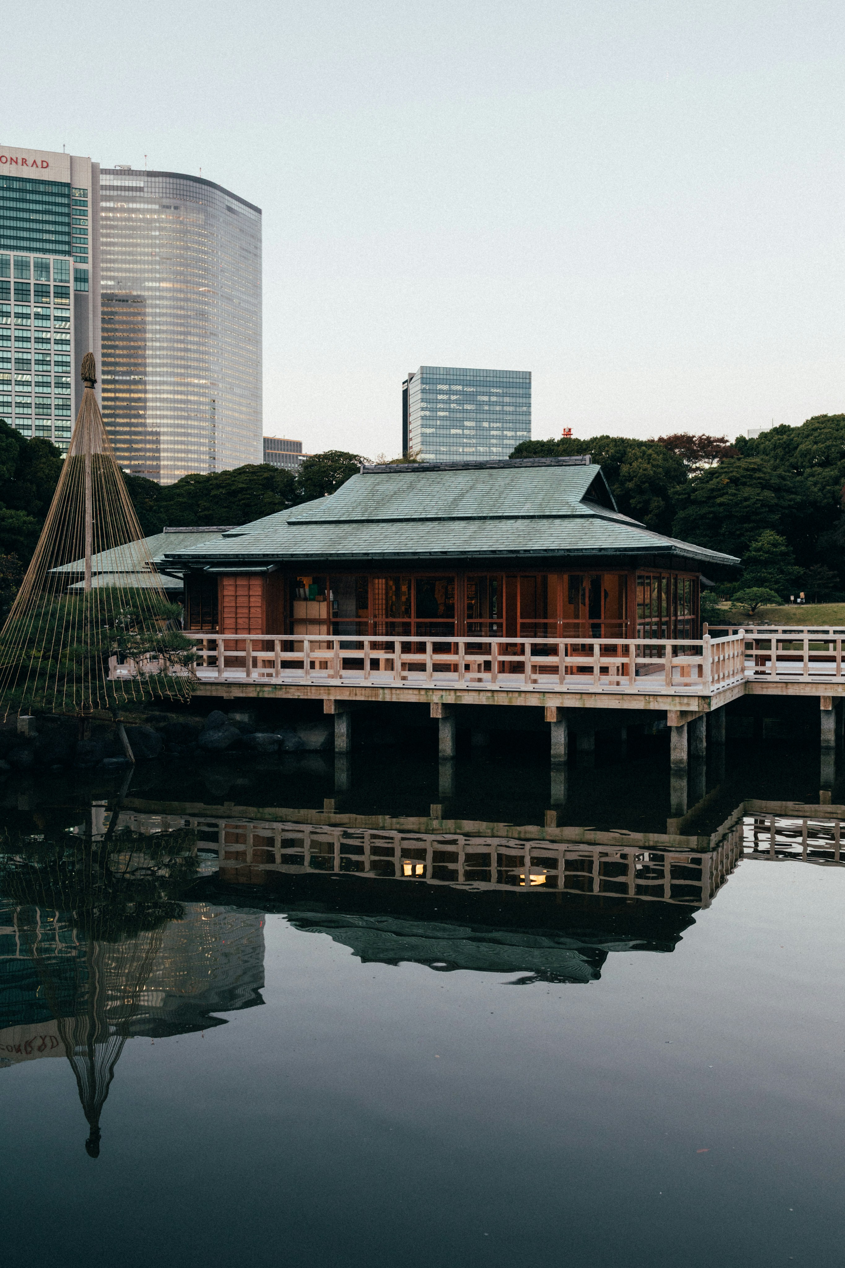 Traditional japanese building reflected in calm water.