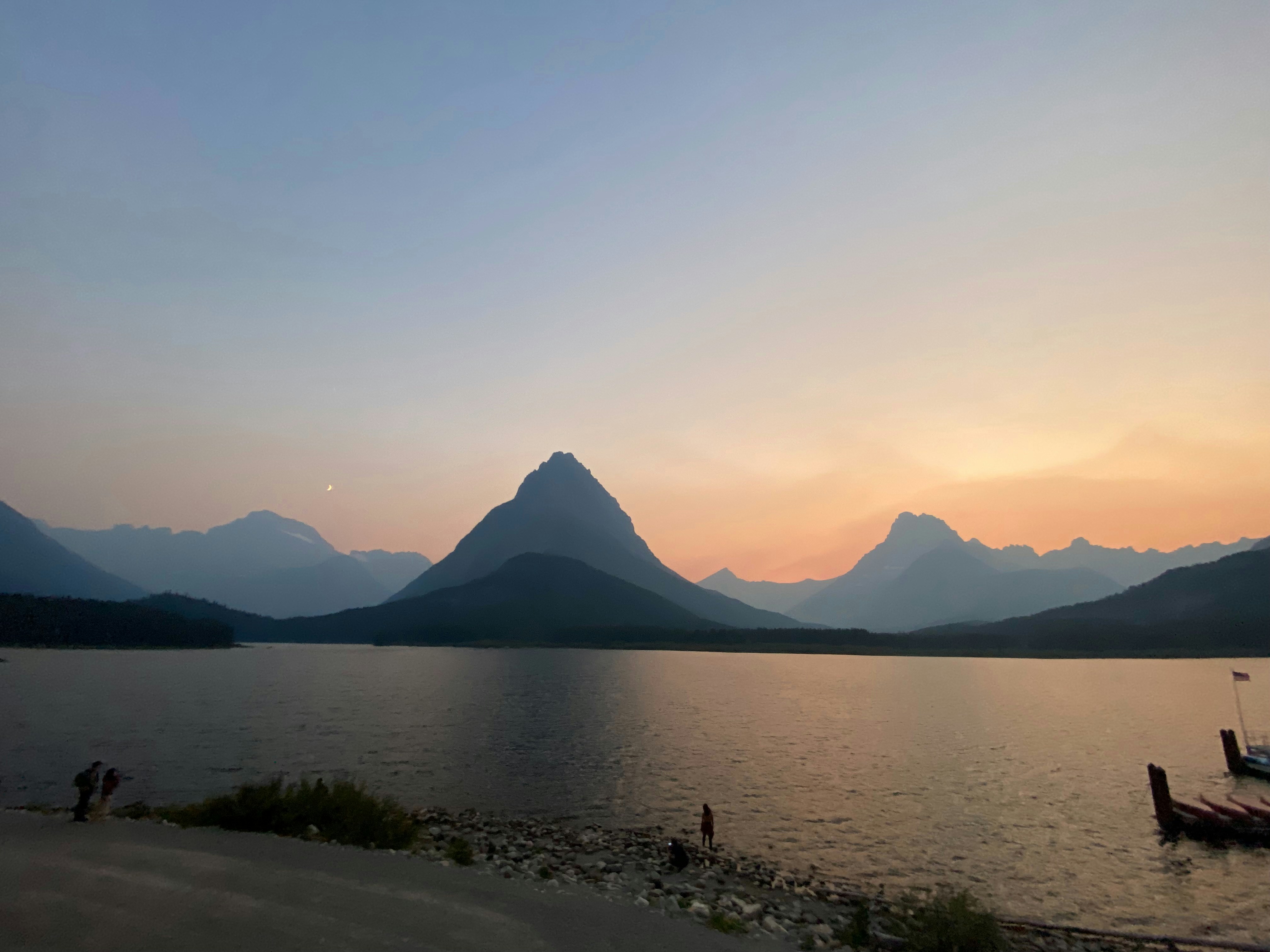 Mountains reflect on a lake at dusk.