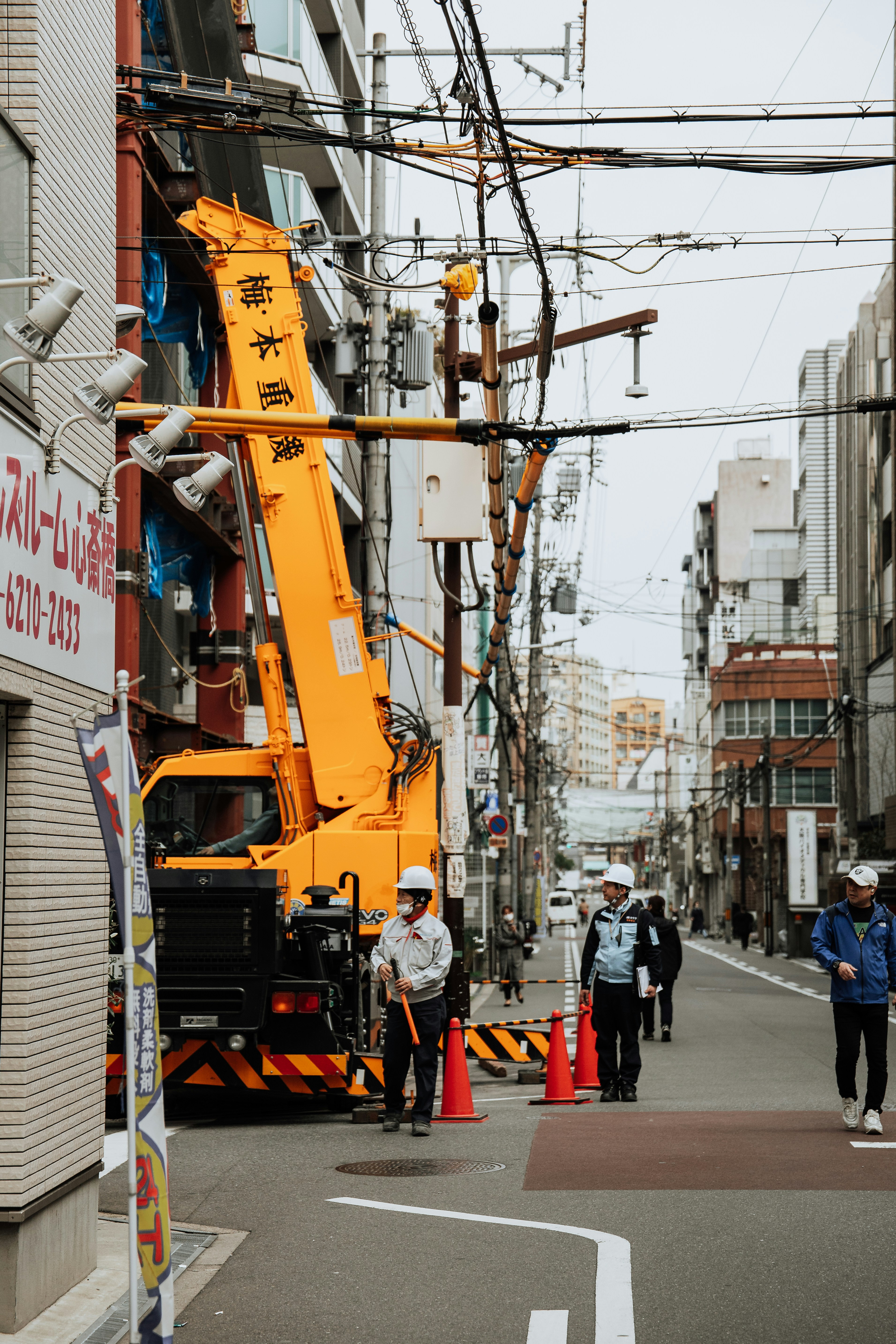 A crane works in a crowded city street.