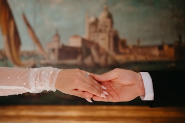 Couple's hands clasped during a romantic moment.
