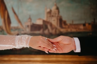 Couple's hands clasped during a romantic moment.