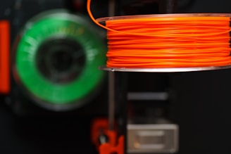 Orange and green filament spools.