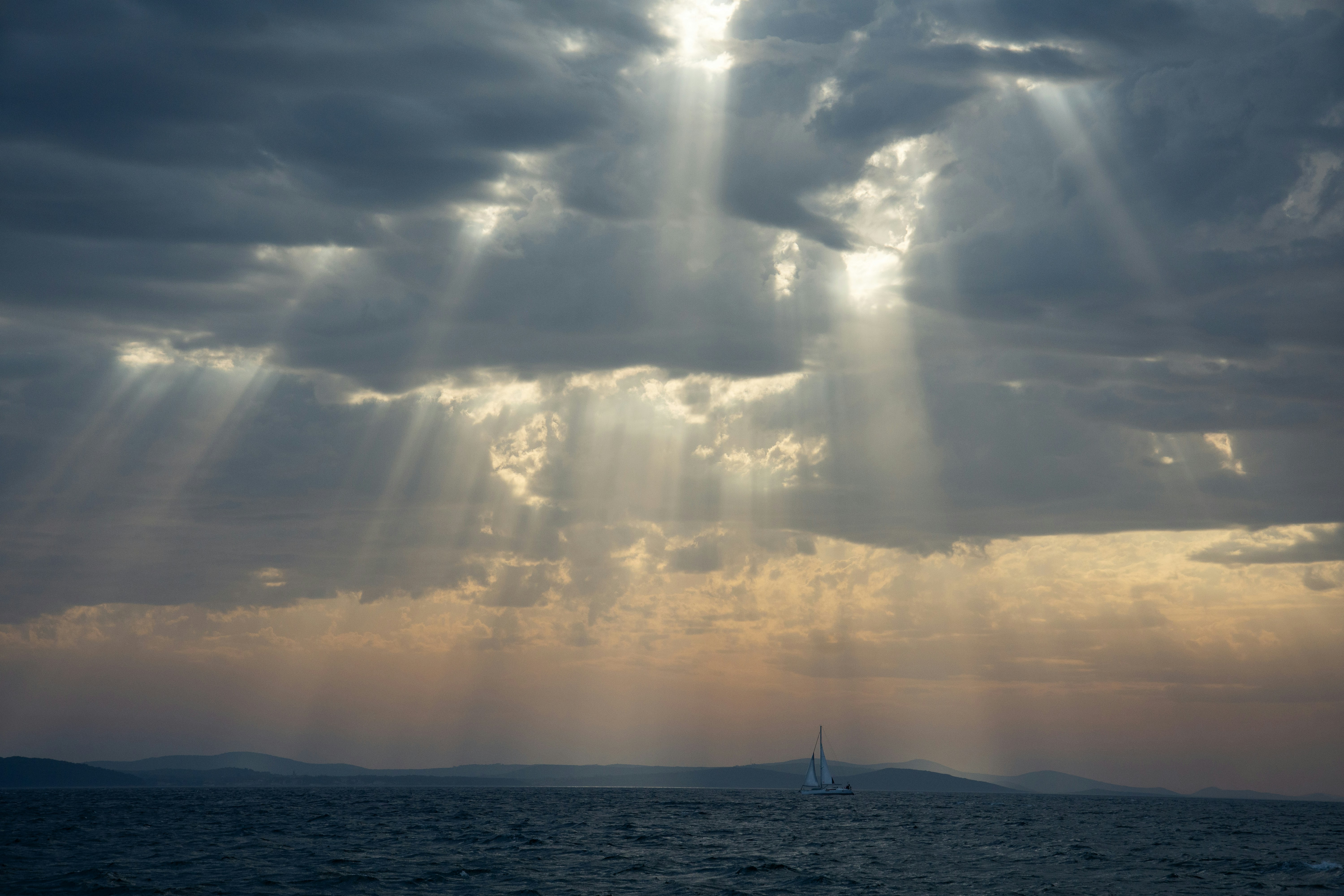 God's rays shine through dramatic, stormy clouds.