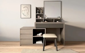 A modern vanity with a mirror and stool.