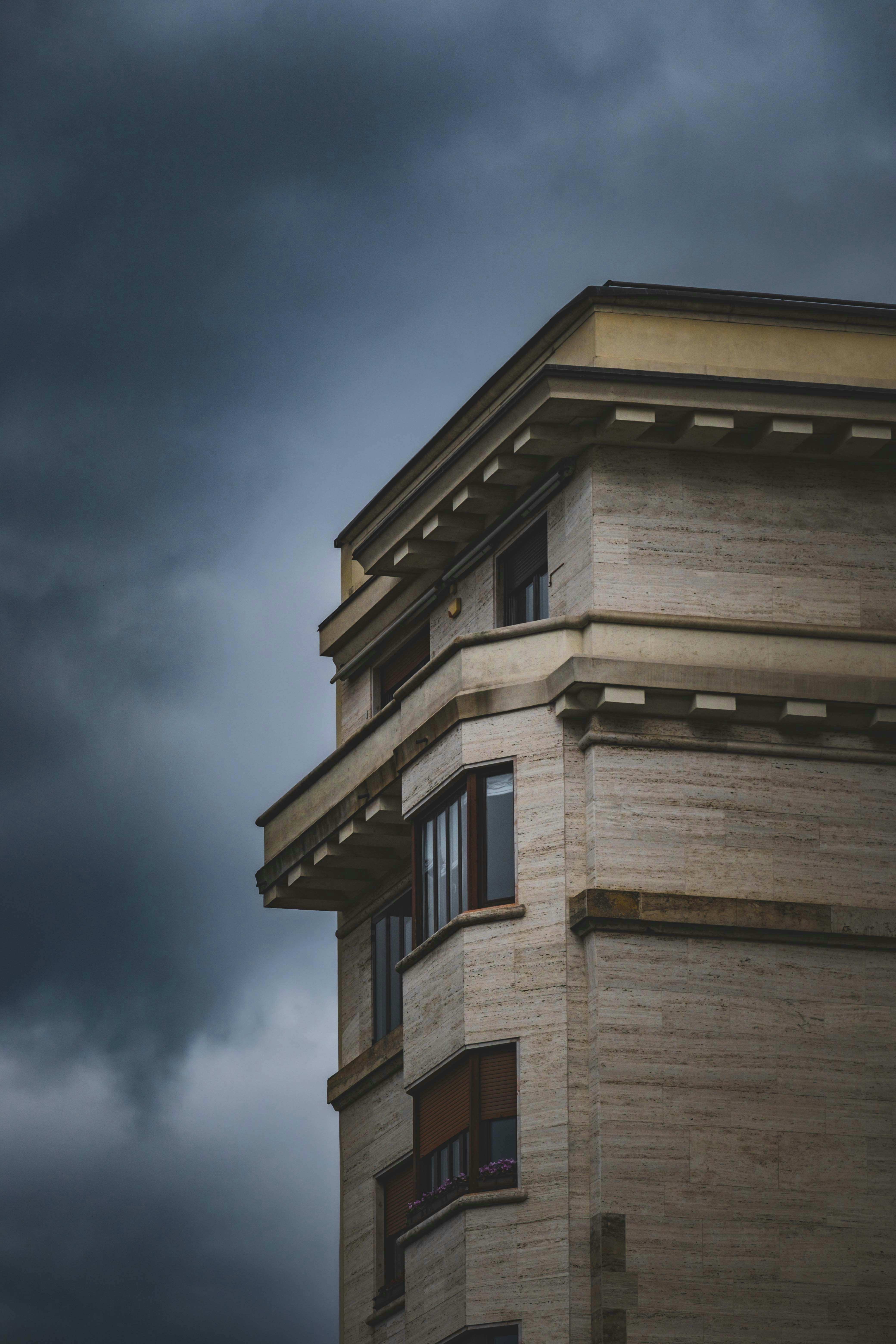 A building's corner against a cloudy sky.