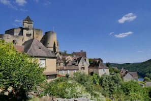Medieval village nestled under a stunning blue sky.