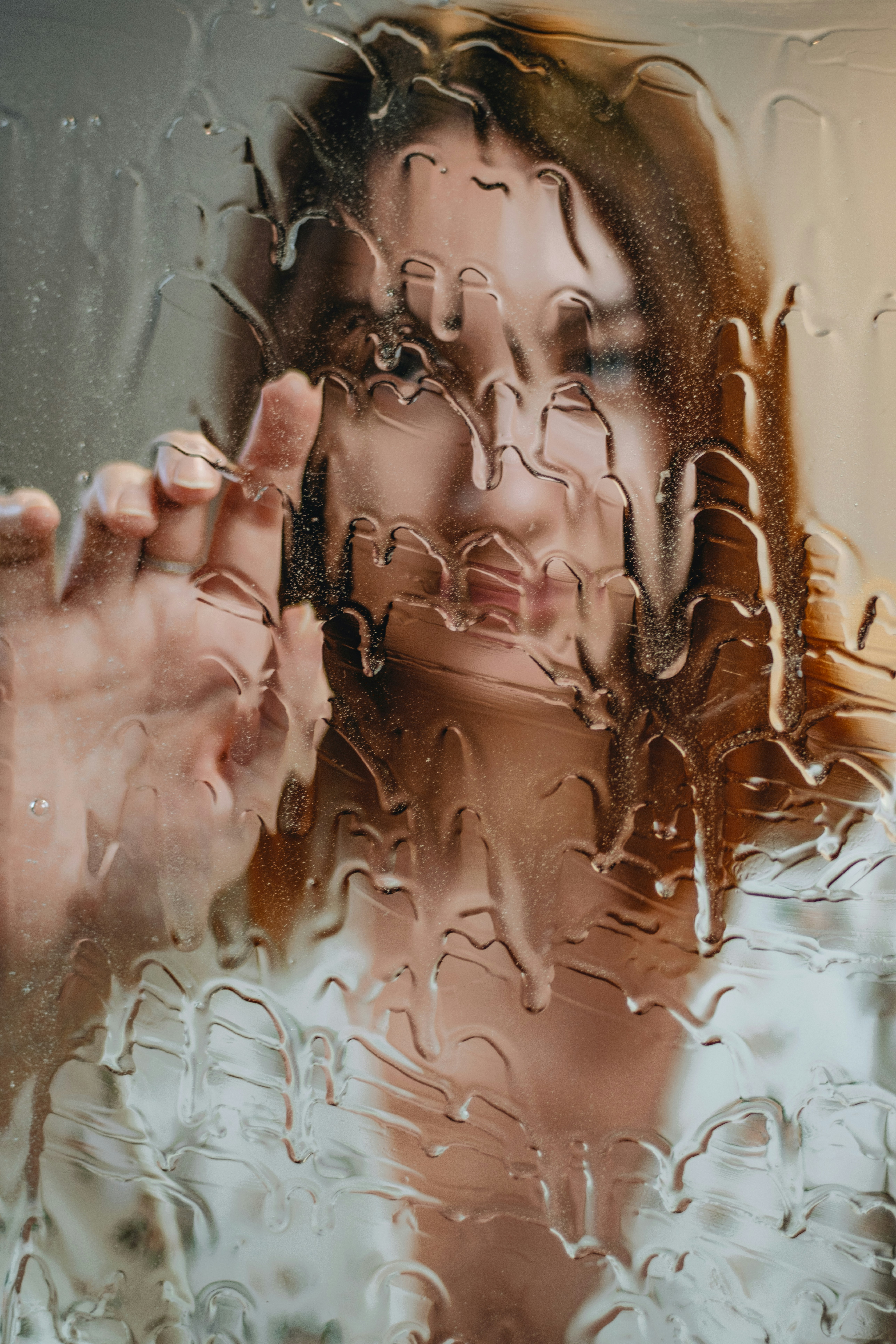 A woman touches a wet surface.