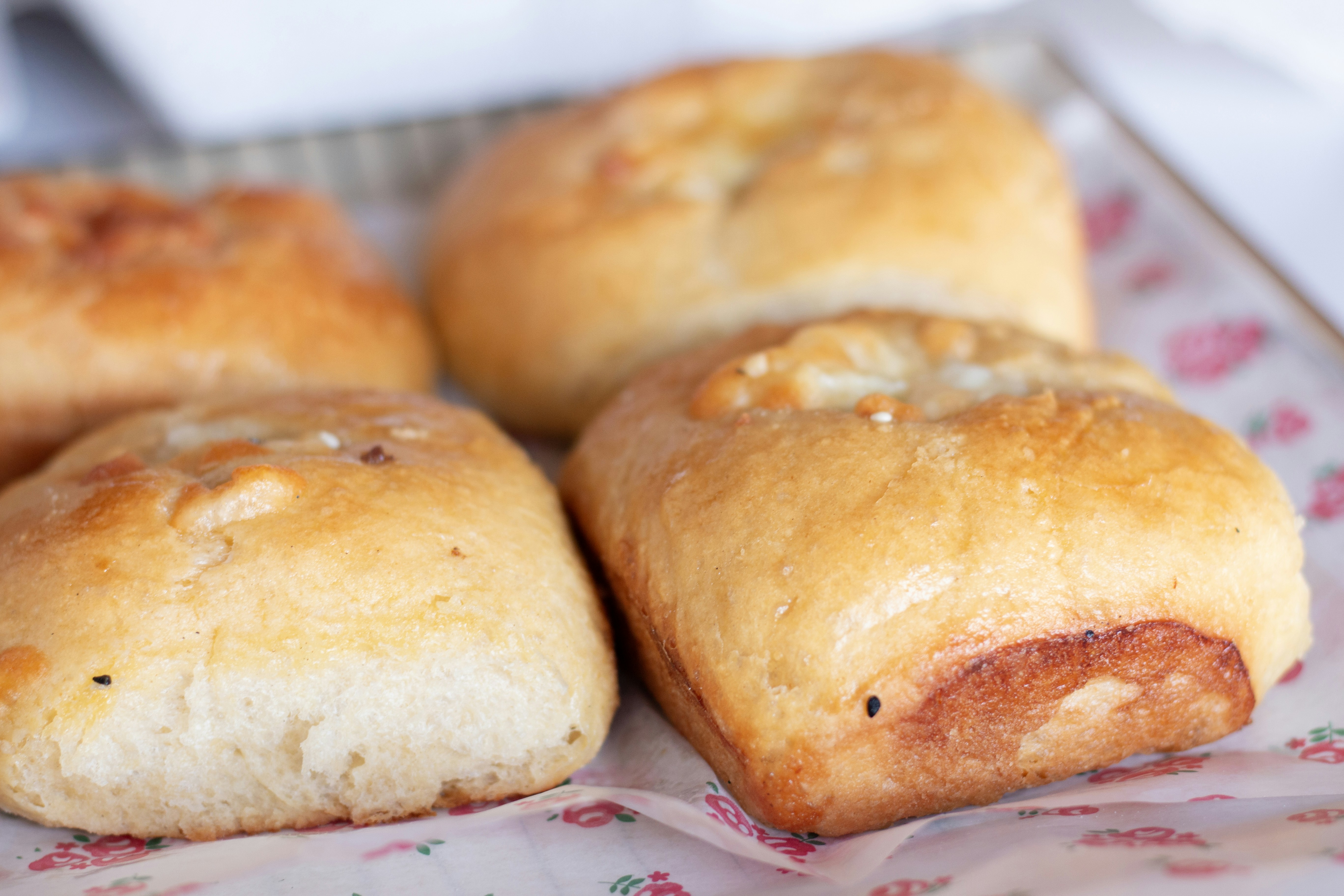 Delicious baked rolls are placed on a tray.