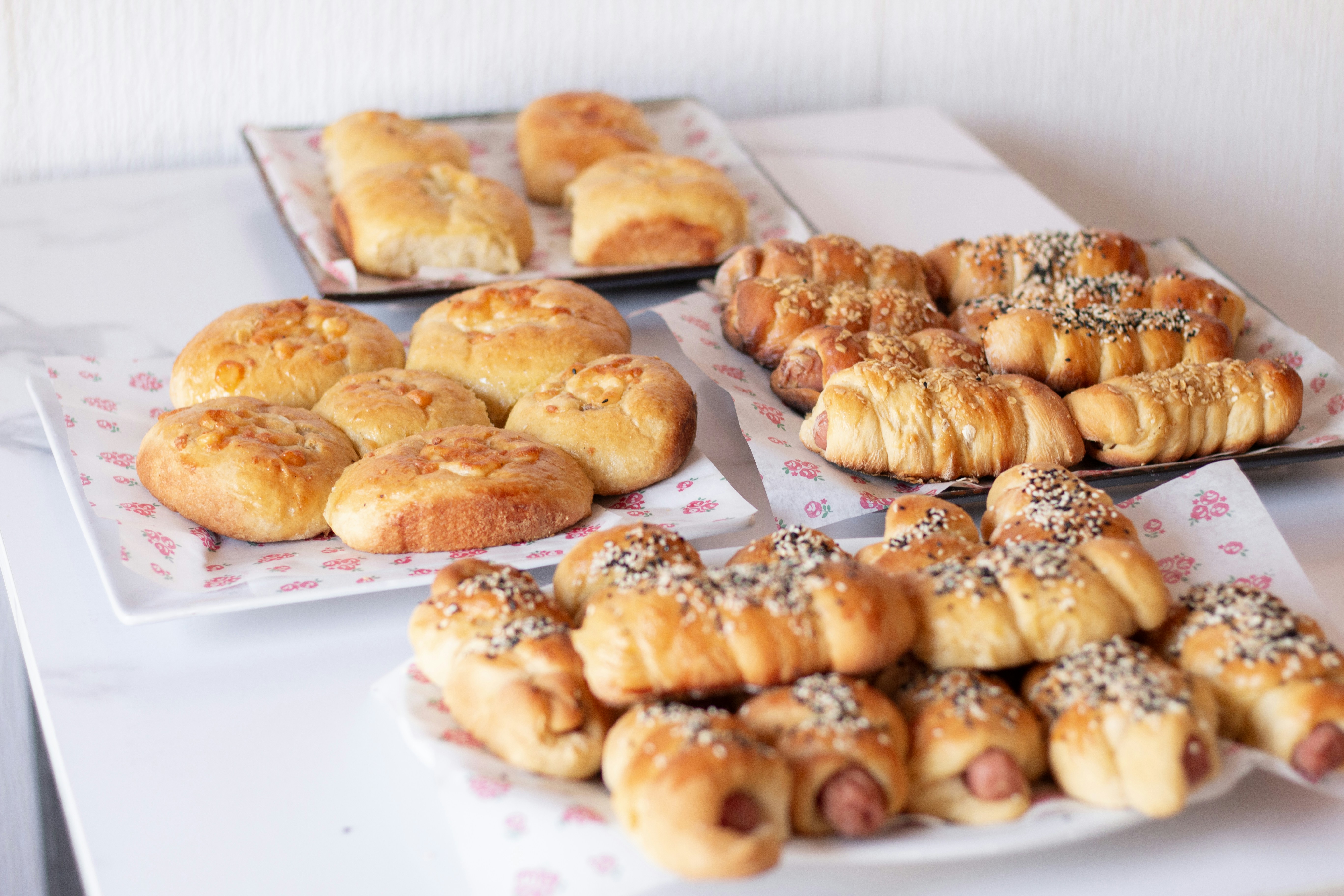 Delicious breads and pastries are arranged beautifully.