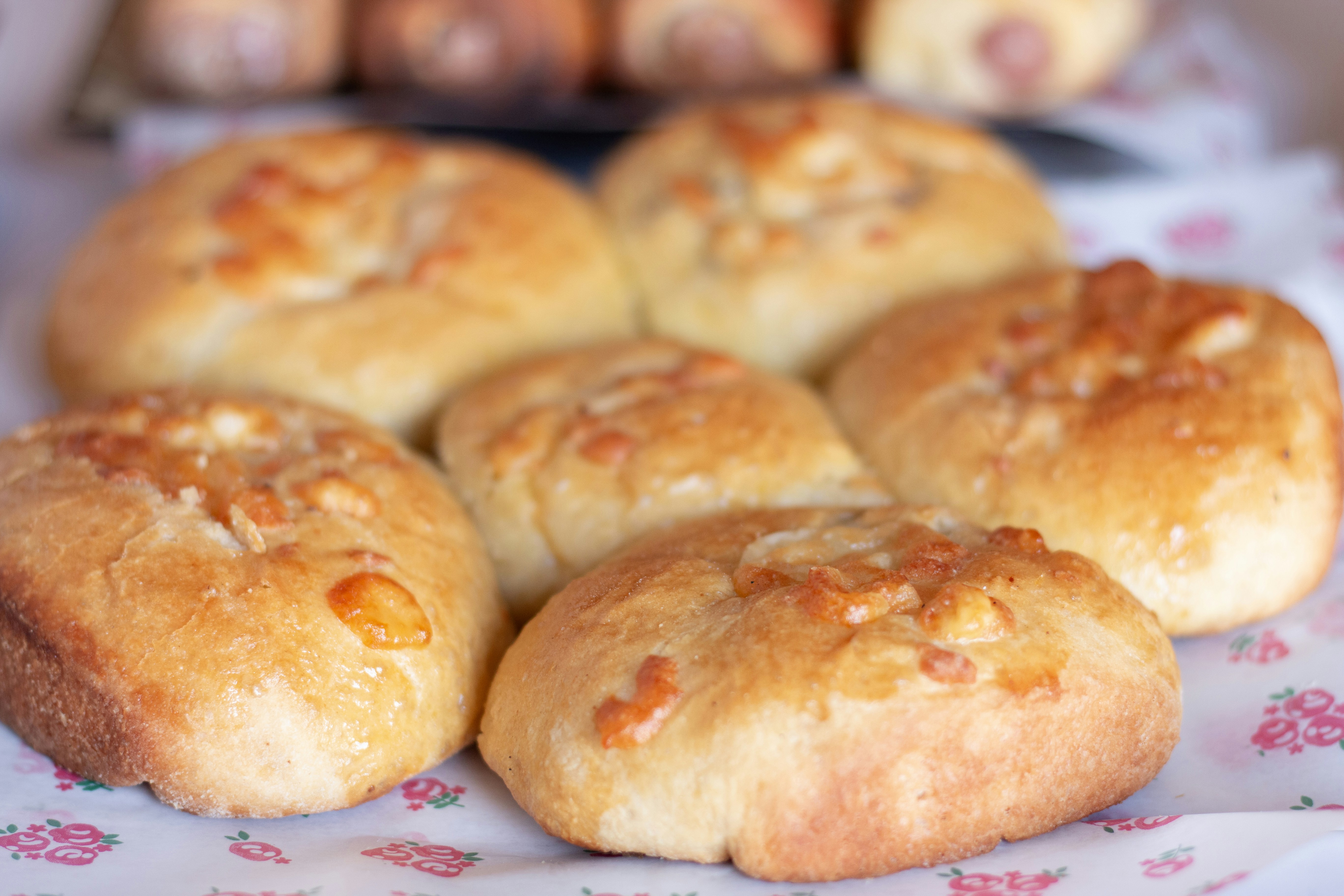 Freshly baked bread rolls with cheese.