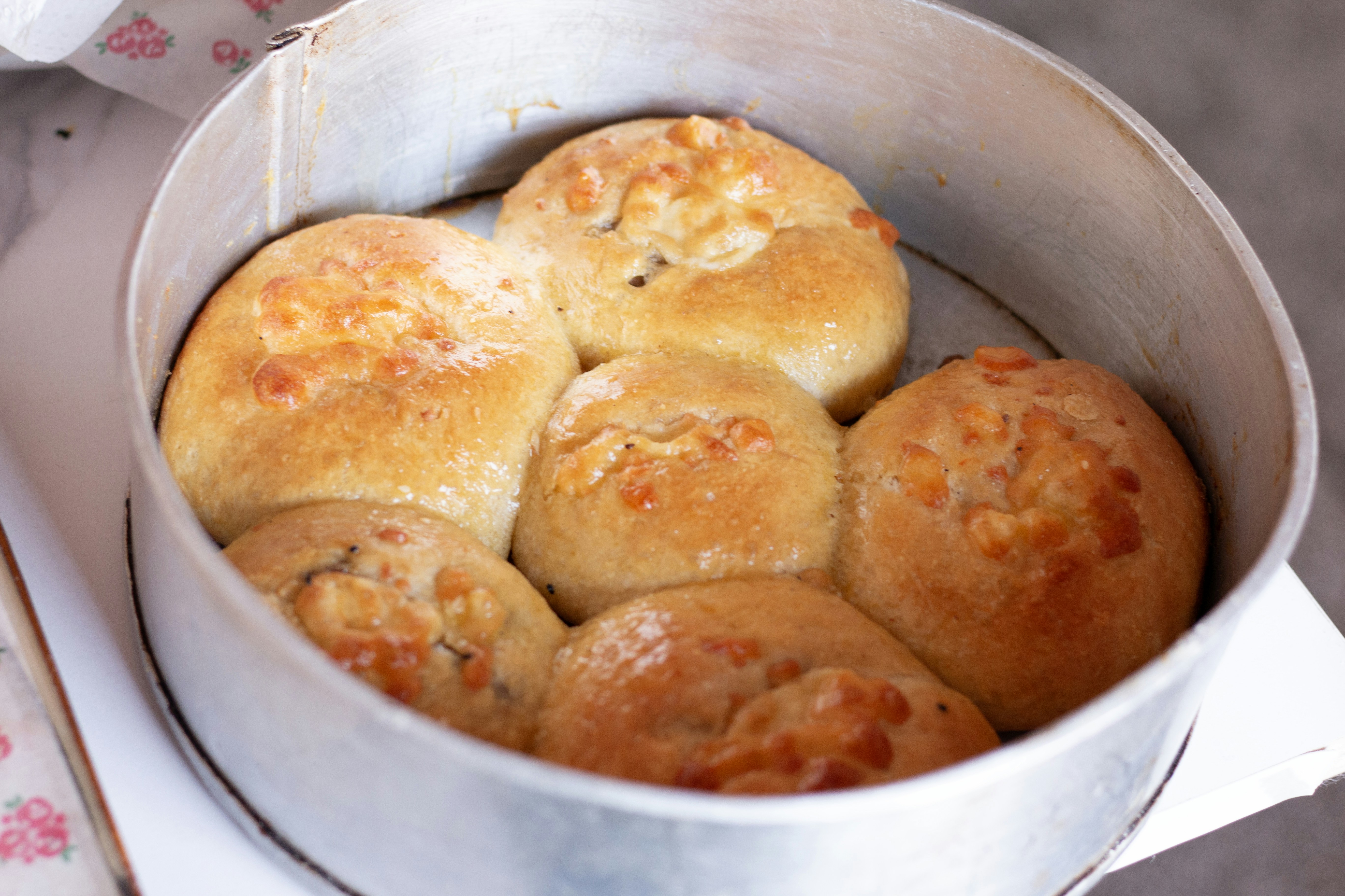 Freshly baked bread rolls in a baking pan.