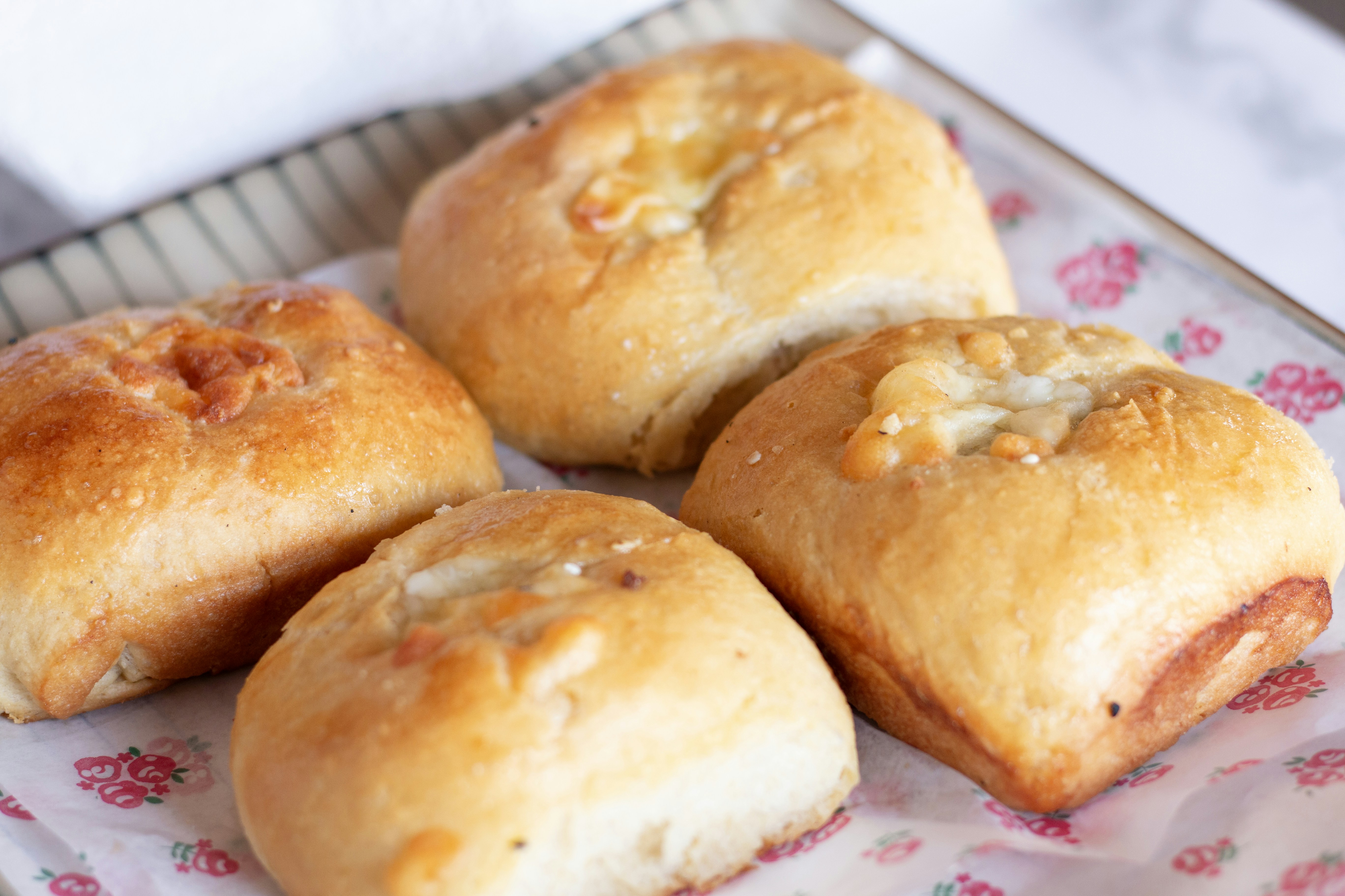 Four delicious baked rolls are ready to be eaten.