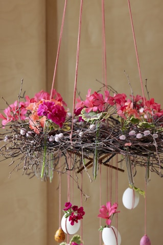 Floral easter arrangement with hanging eggs.