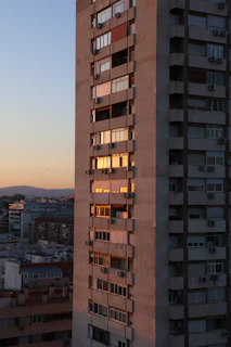 A tall building reflects the evening sunlight.