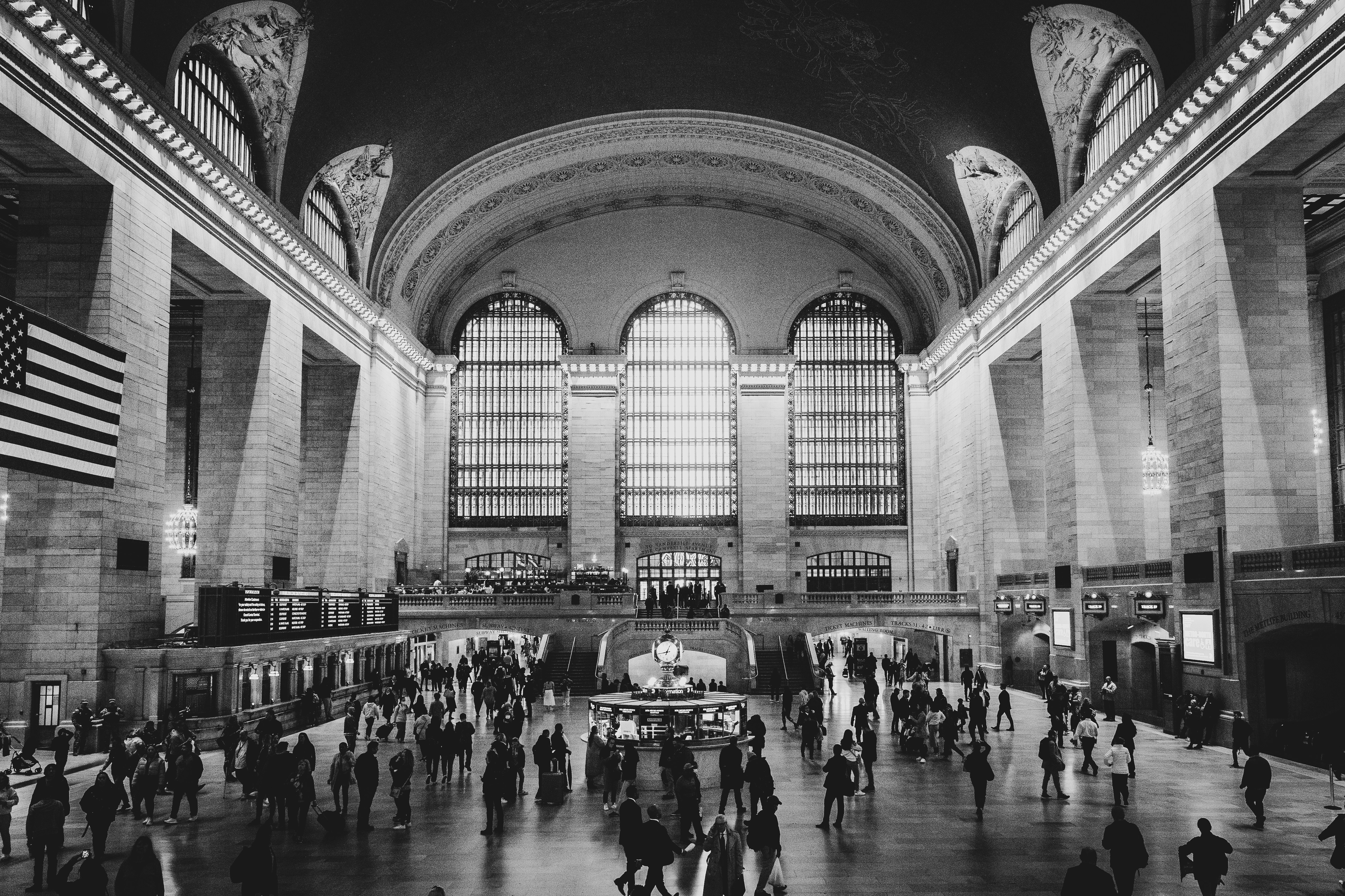 People walk inside of grand central terminal.