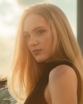 A young woman poses with long blonde hair.