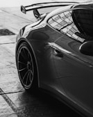 A sleek porsche in monochrome sits stationary.
