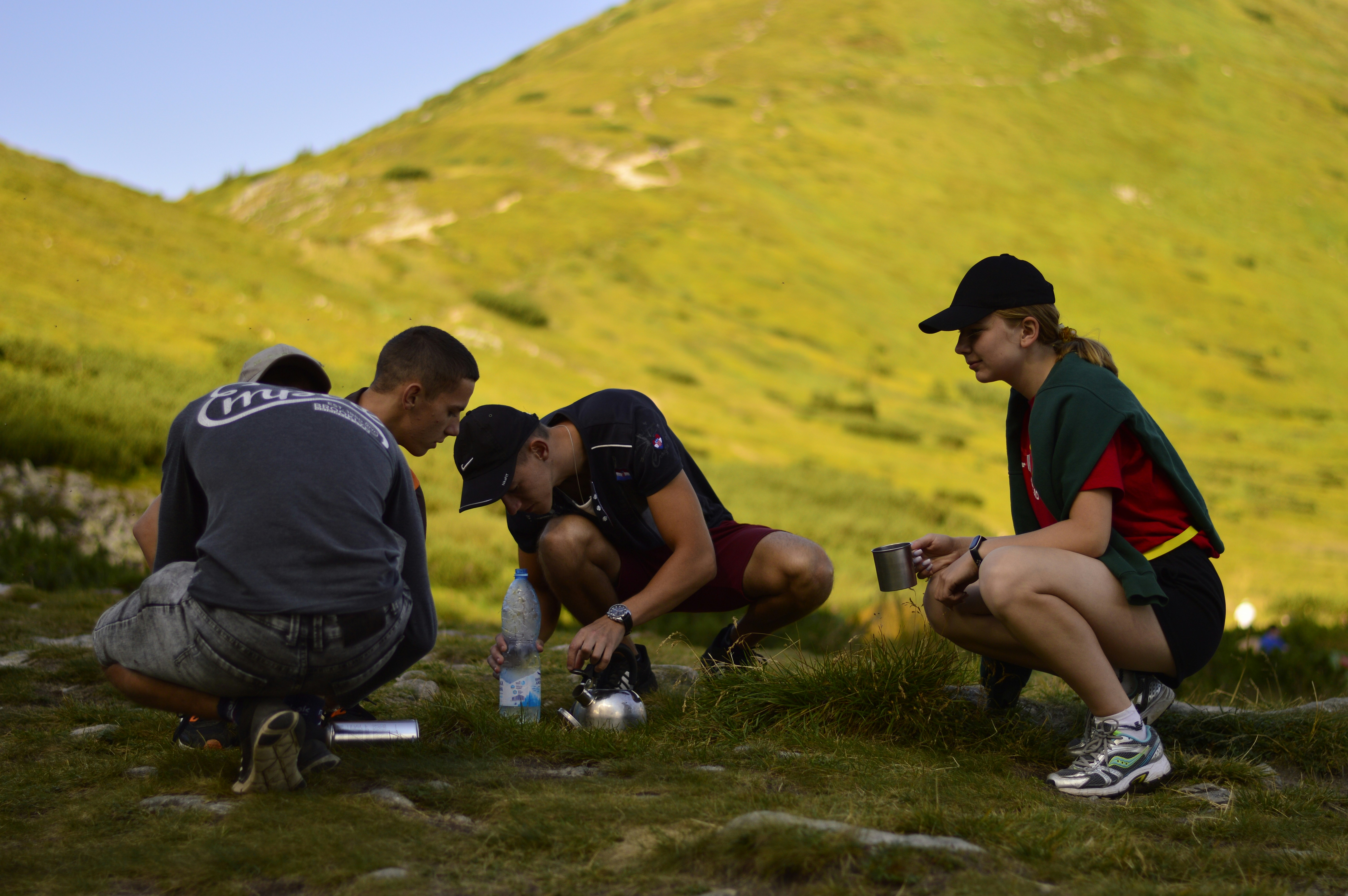 Hikers take a break on a grassy mountain
