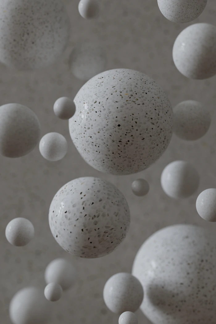 White spheres float against a speckled background
