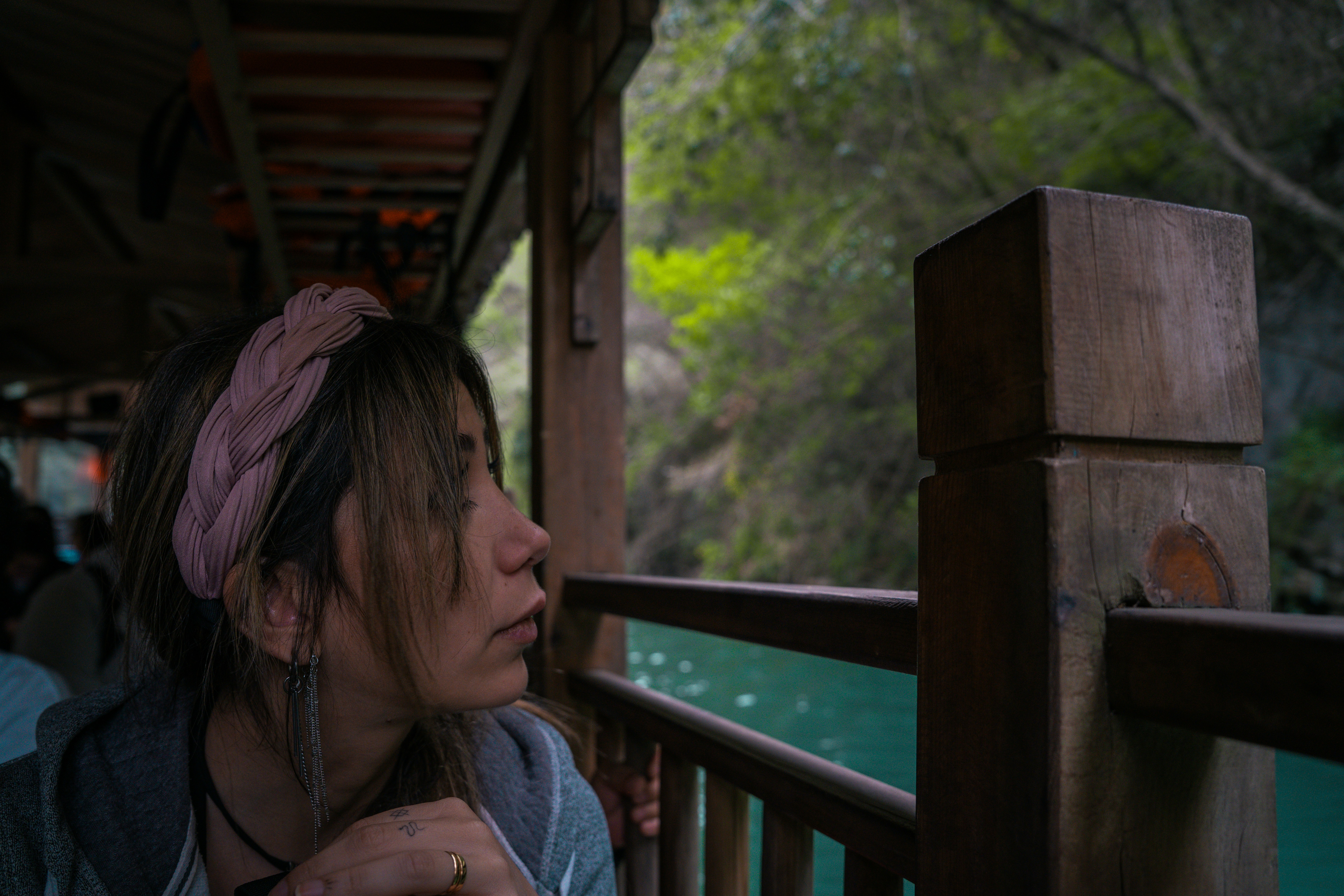 Woman on a boat looks at a beautiful landscape.