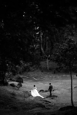 Bride and groom in a forest setting.